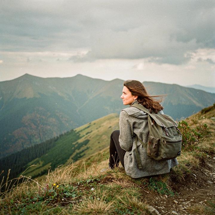 Guest resting on a grassy ridge above the treeline in the Chornohora range on a September weekend